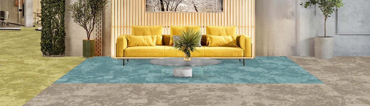 Snowfall carpet tiles installed in zones of different colours of blue, light grey and green